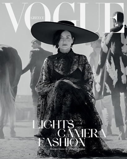 Vogue Greece cover featuring Sharon Stone in a wide-brimmed hat and black lace dress, posing in a desert-like setting with other models.