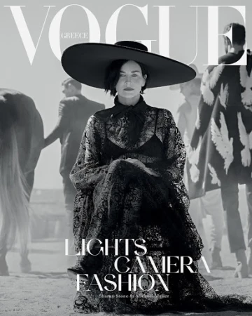 Vogue Greece cover featuring Sharon Stone in a wide-brimmed hat and black lace dress, posing in a desert-like setting with other models.