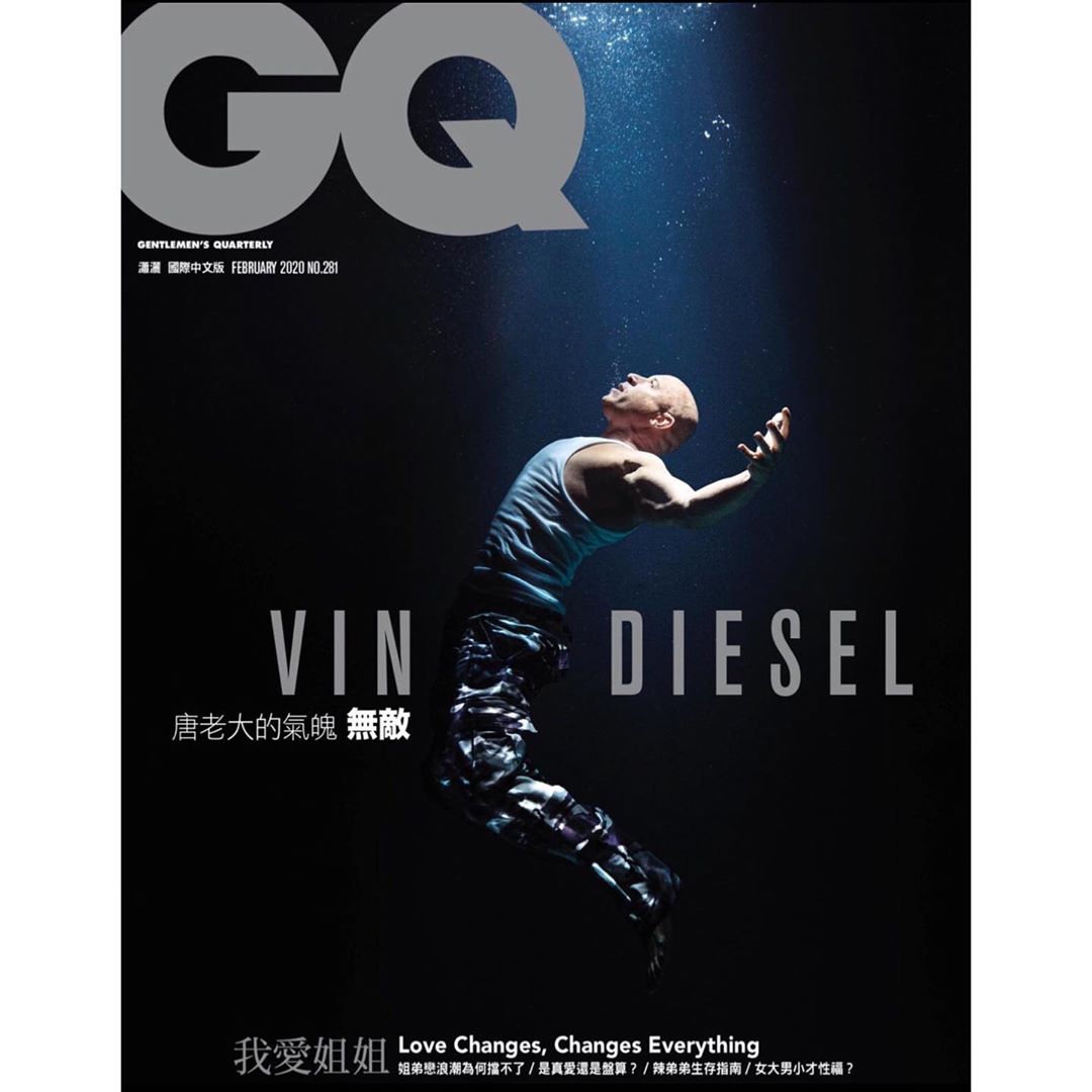 Vin Diesel on the cover of GQ Magazine, floating in water with a spotlight. He is wearing a tank top and patterned pants.