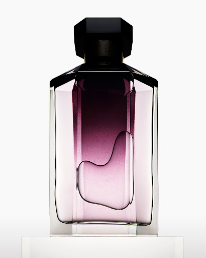 Elegant clear glass perfume bottle with a dark purple gradient fill and a black geometric cap on a white surface.