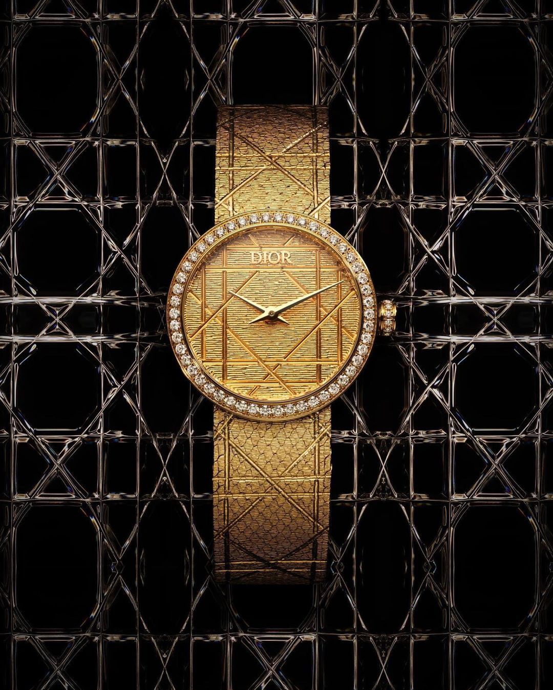 Elevated, eye-level studio shot showcases a gold Dior watch featuring a diamond bezel and a patterned dial on a black patterned surface.