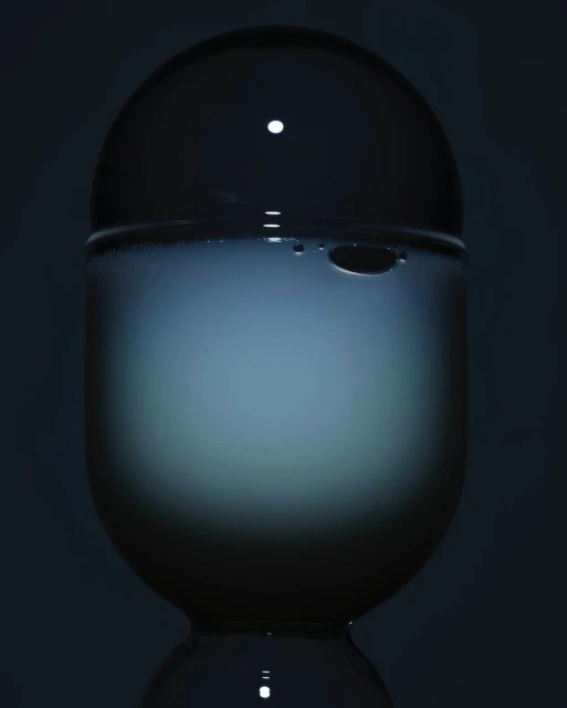 Crystal ball sits atop a pedestal, its translucent surface reflecting a soft, diffused light against a dark backdrop.