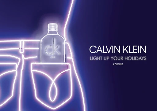 Neon outline of jeans against dark background with a perfume bottle in the pocket and Calvin Klein typography