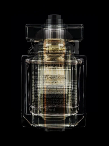 Luxury perfume bottle featuring both Chanel and Miss Dior branding with overlapping translucent glass design on a stark black backdrop.