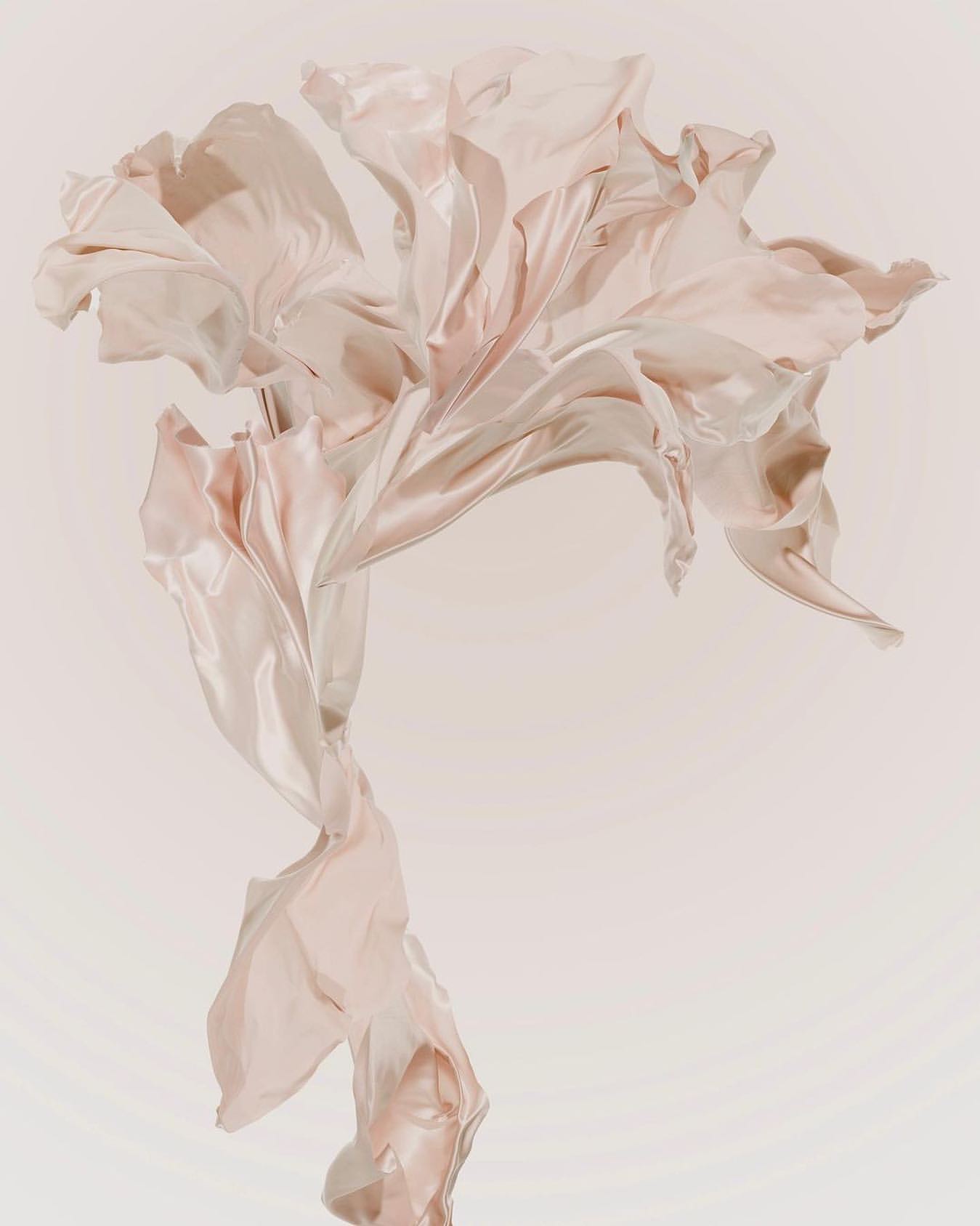 Pale pink satin fabric floating against a light background, creating an elegant and fluid composition.