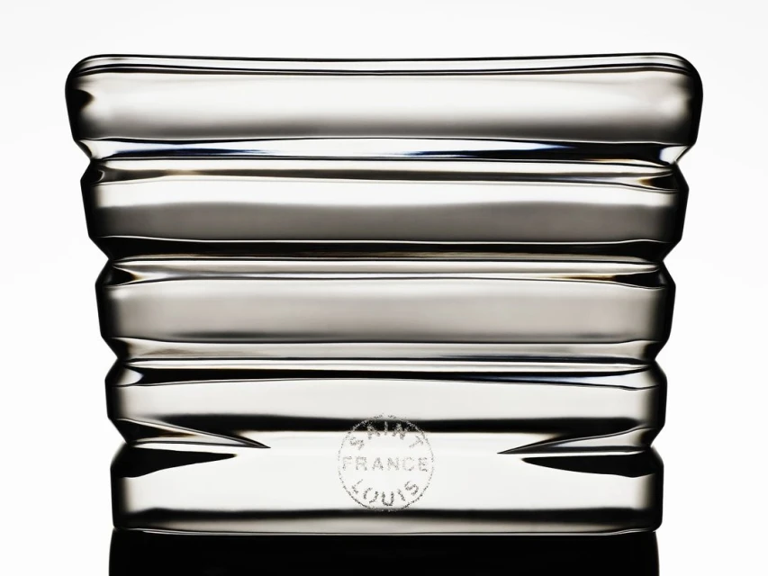 Elegant clear crystal glass vase with horizontal textured lines and reflective surface, displayed against a white background.