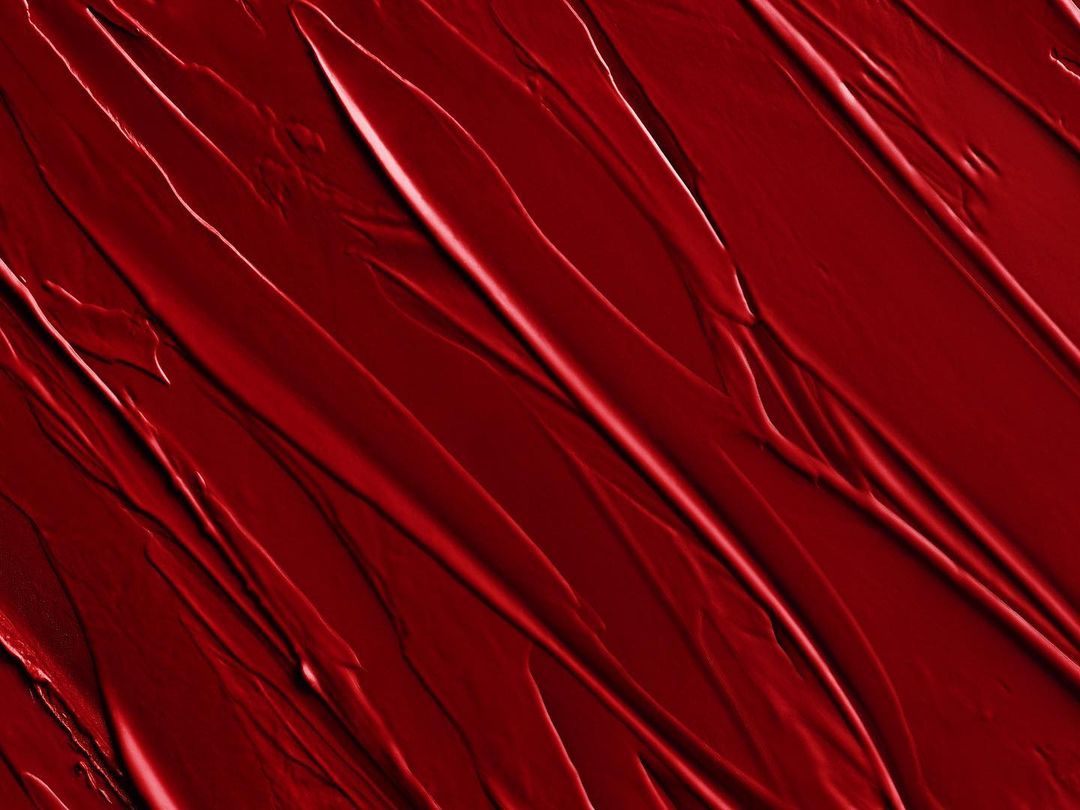 Abstract image of red textured paint strokes, creating a dynamic pattern with varying shades and highlights, ideal for backgrounds.