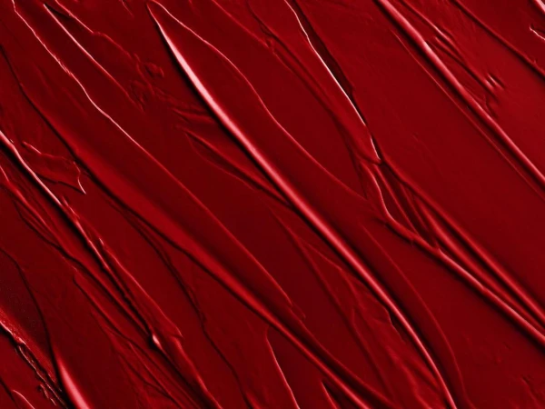Abstract image of red textured paint strokes, creating a dynamic pattern with varying shades and highlights, ideal for backgrounds.