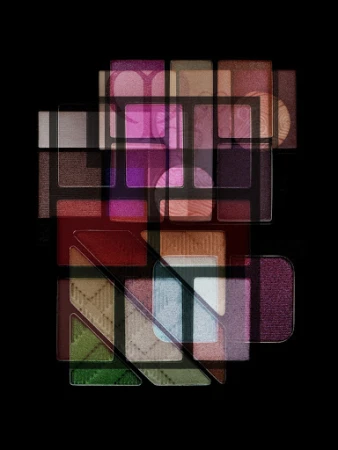 Overlapping multi-exposure abstract composition of various colorful makeup eyeshadow palettes against a solid black background.