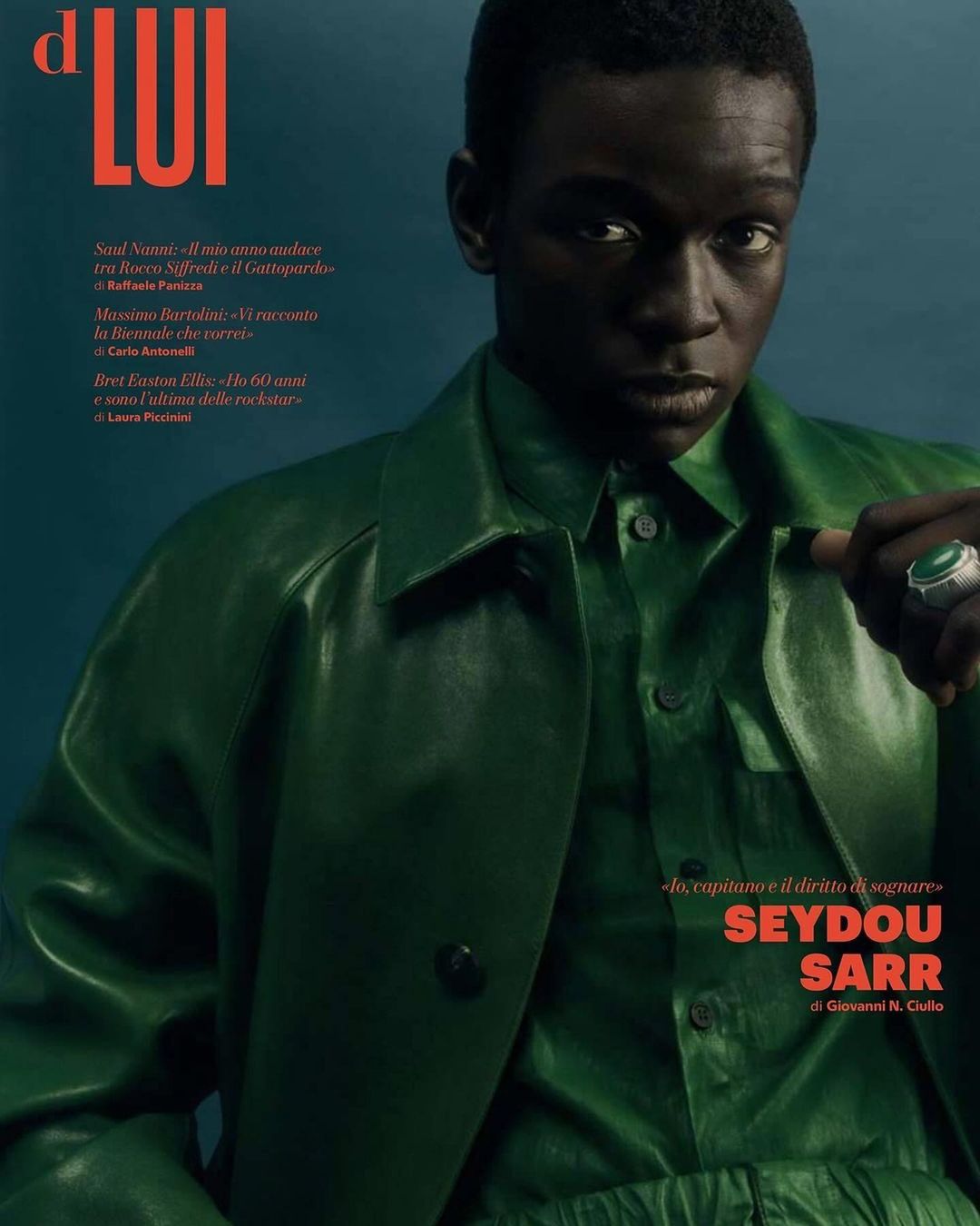 Magazine cover featuring Seydou Sarr, an adult male of African descent, wearing green clothing, accessorized with a statement ring. Portrait.