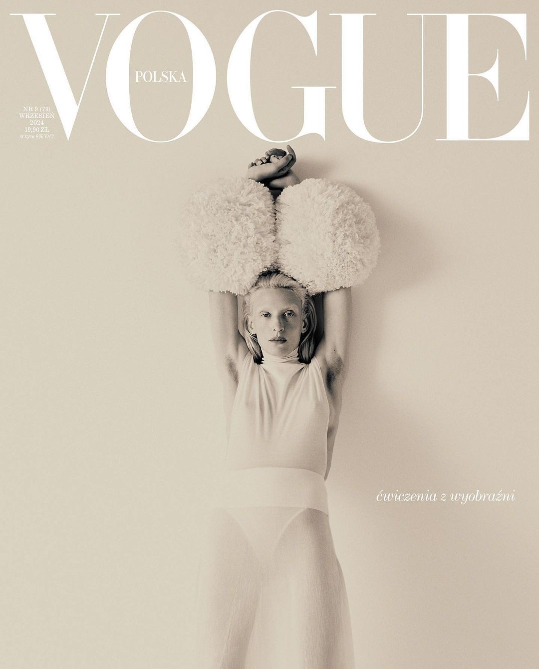Vogue Polska cover featuring a person in a white bodysuit with large, fluffy shoulder pieces, with the magazine's logo at the top.