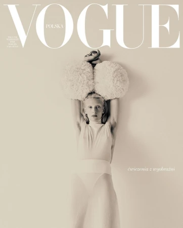 Vogue Polska cover featuring a person in a white bodysuit with large, fluffy shoulder pieces, with the magazine's logo at the top.