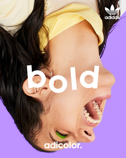 Upside-down headshot of a young woman with green eye makeup on a purple background, featuring the text overlay 'bold' and Adidas logo.