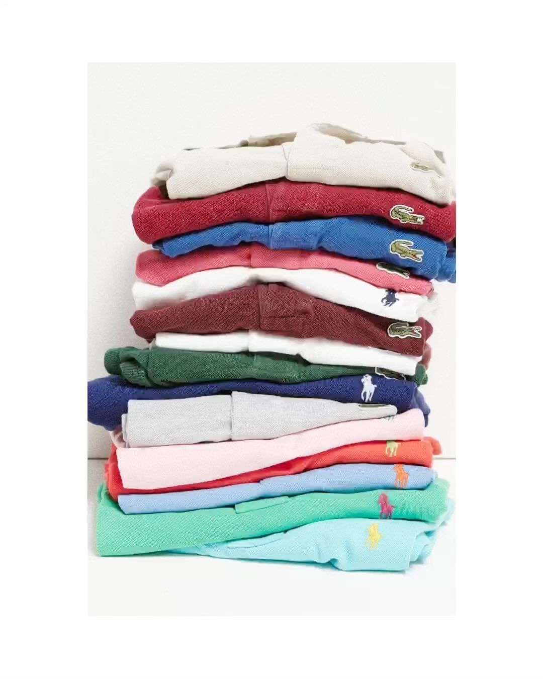 Stack of colorful polo shirts with brand logos, including Lacoste and Ralph Lauren, on a white background, clean and neatly folded.