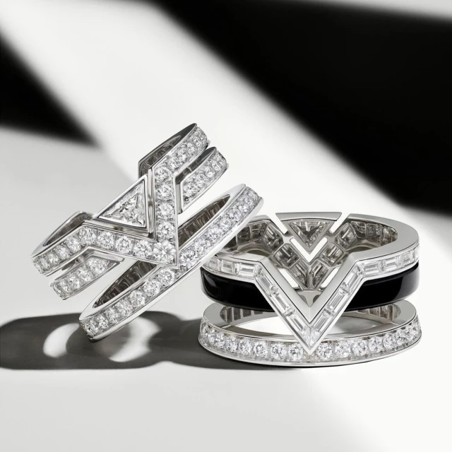 Close-up studio shot of two geometrically shaped diamond rings with black onyx, emphasizing luxury jewelry design, sparkle, and modern elegance.
