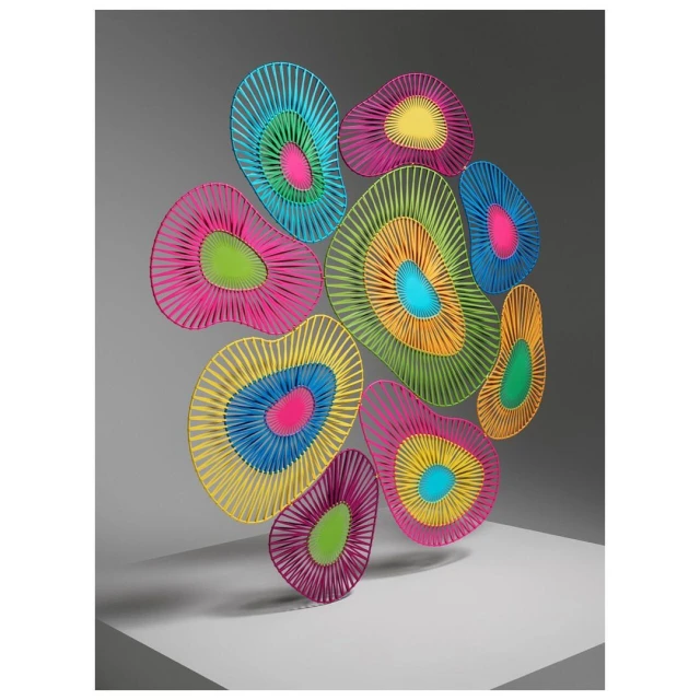 Colorful abstract wall art installation featuring geometric shapes and vibrant neon concentric circles on a white and gray background.