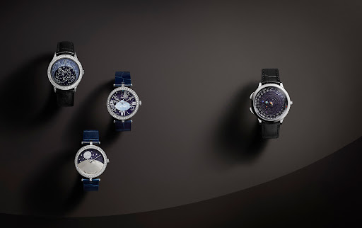 Four luxury wristwatches with diamond bezels, blue and black leather straps, and decorative dials on a gradient grey background.