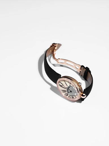 Elegant women's wristwatch with an oval face, black band, and rose gold hardware, set against a clean white background for product showcase.