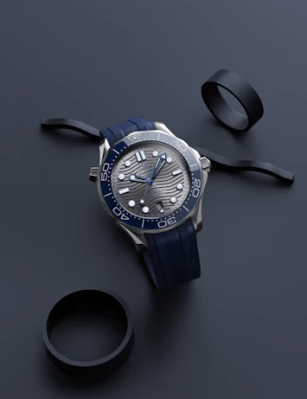 Elegant wristwatch with blue rubber strap and silver casing on a dark blue background, complemented by black decorative rings.