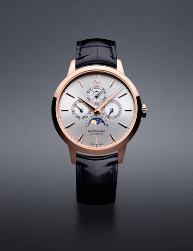 Elegant gold-tone Montblanc wristwatch with black leather band displayed on a gray background. The watch face features subdials and moon phase.