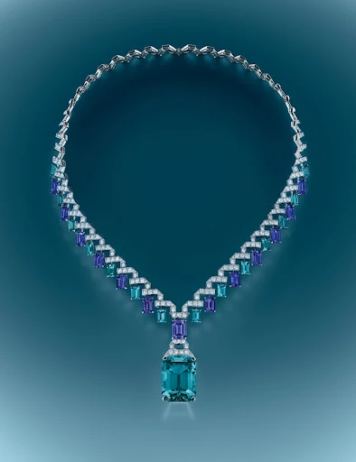 Elegant necklace featuring blue and white gemstones on a teal gradient background, jewellery, close-up product shot for luxury fashion.