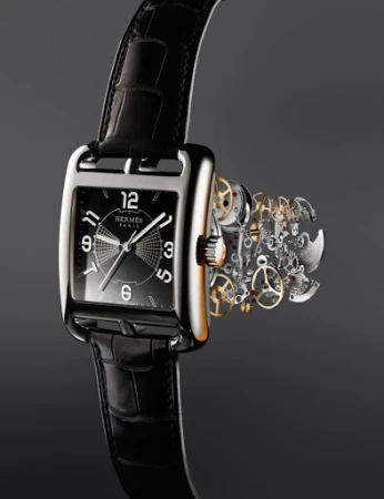 Elegant Hermès watch with black leather strap, silver case, black dial, and visible watch mechanism on a seamless dark gradient background.