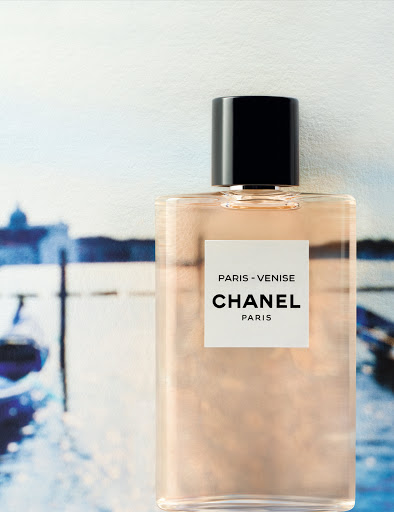 Chanel Paris-Venise perfume bottle on blurred Venice canal background. Cosmetic advertising with luxury branding and visual appeal.