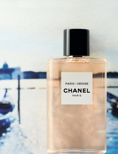 Chanel Paris-Venise perfume bottle on blurred Venice canal background. Cosmetic advertising with luxury branding and visual appeal.