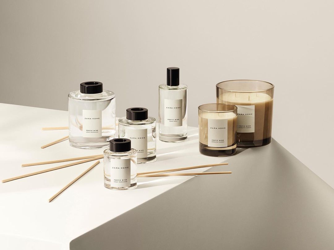 Zara Home fragrance diffusers and candles in clear glass containers arranged on a light gray surface with neutral studio background.