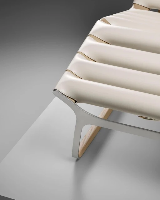 Modern lounge chair with a tubular metal frame and white leather seat in a minimalist interior setting. Sophisticated design.