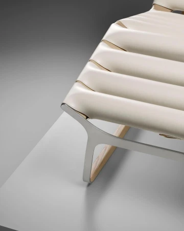 Modern lounge chair with a tubular metal frame and white leather seat in a minimalist interior setting. Sophisticated design.