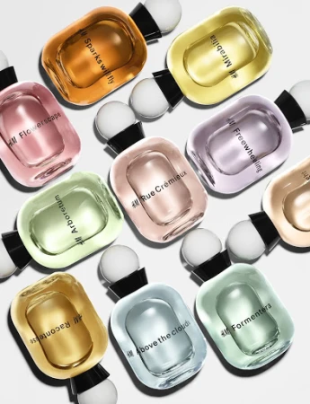 Collection of H&M perfume bottles in various colors and scents including Mirabilia, Sparks Will Fly, and Arboretum on white.