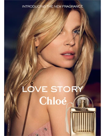 Blonde woman poses in a beauty shot with a gold Chloe perfume bottle in the foreground for a fashion and fragrance advertisement.