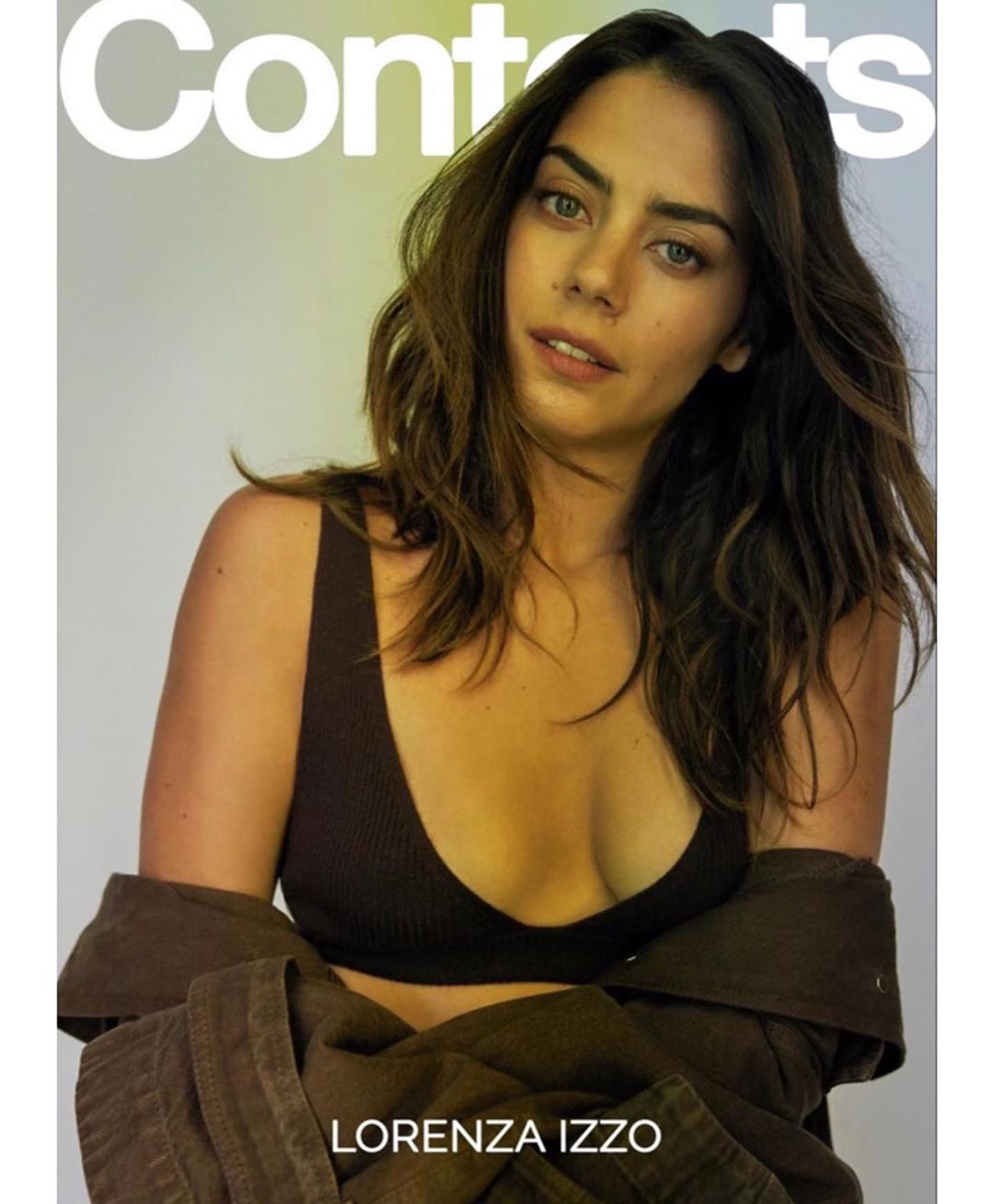Portrait of Lorenza Izzo wearing a black top and jacket against a soft gradient background. Cover of Contents magazine.