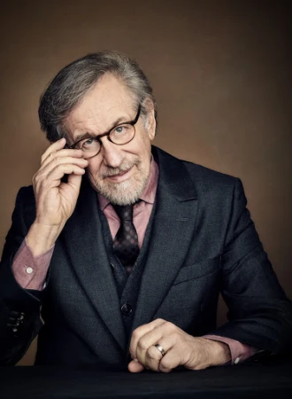Steven Spielberg in a dark suit jacket and glasses, photographed by Rainer Hosch.