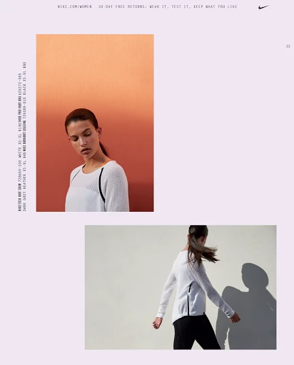 A woman poses indoors in a Nike ad. She is wearing a white long-sleeved athletic top and black pants. The background has color gradients.