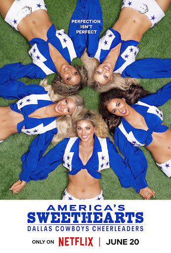 Dallas Cowboys cheerleaders pose in a circle on green field. Cheerleaders are wearing blue and white uniforms in overhead shot.