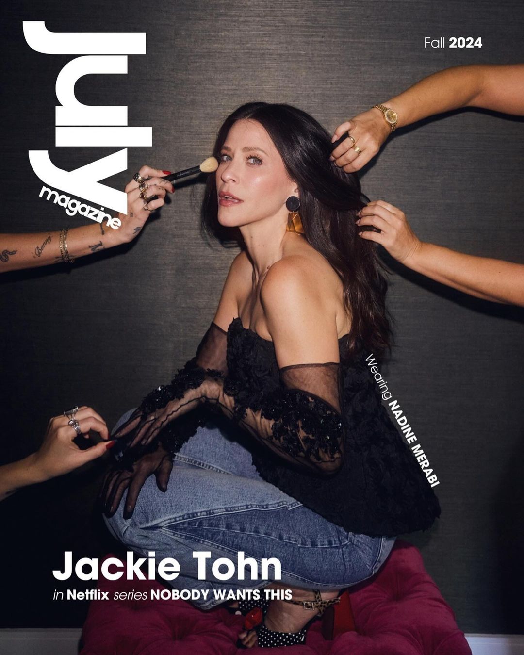 Magazine cover featuring Jackie Tohn, makeup application, Fall 2024 edition. Three sets of hands work on hair and makeup, dark textured background.