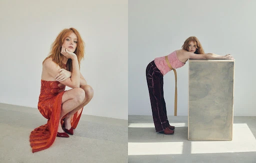 Two red-haired female fashion models strike unique poses in a studio with bright lighting while wearing modern clothing.