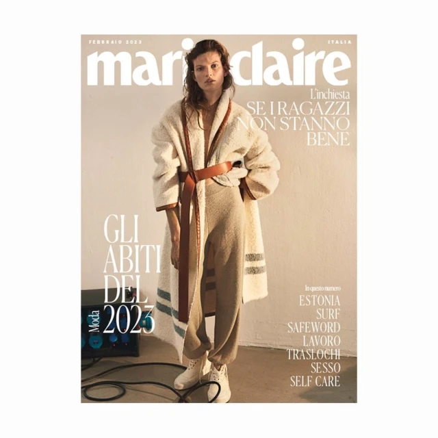 Marie Claire Italia magazine cover featuring a model in a cream-colored outfit with a brown belt and white sneakers, photographed indoors.