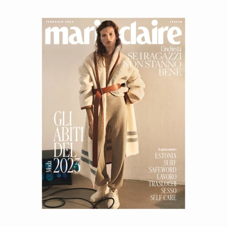 Marie Claire Italia magazine cover featuring a model in a cream-colored outfit with a brown belt and white sneakers, photographed indoors.