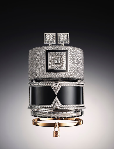 Stacked diamond and gold bracelets and cuffs featuring various textures and geometric designs against a soft gradient background.