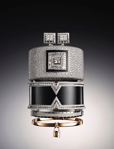 Stacked diamond and gold bracelets and cuffs featuring various textures and geometric designs against a soft gradient background.
