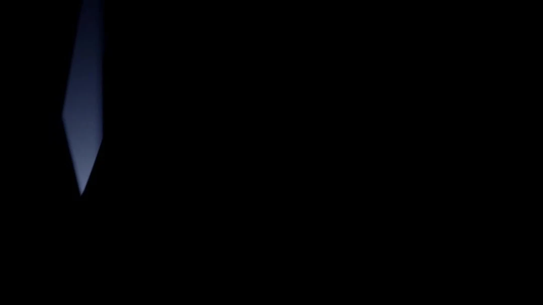 Abstract image featuring a gradient of blue light against a stark black background, creating a dramatic and minimalist visual effect.