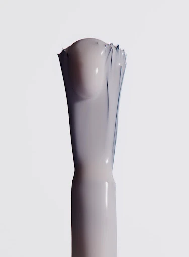 Close-up of a nail polish brush with a light-colored liquid on a bright white background in portrait orientation. Beauty product.