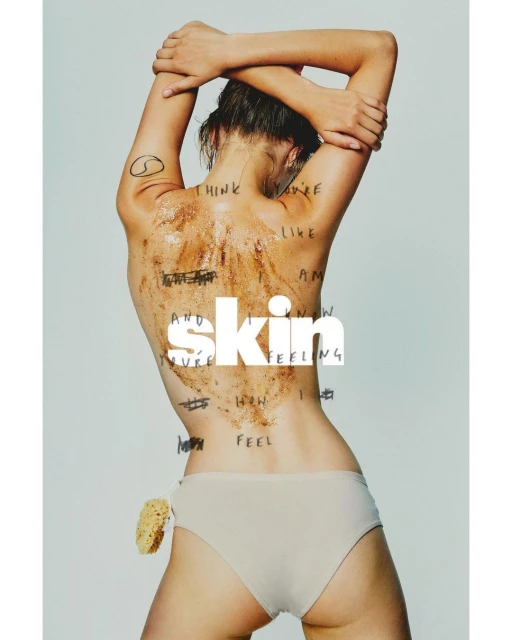 Woman with body scrub stands with arms raised. The word 'skin' is overlaid on her mid back. Body scrub and handwritten text detail her back.