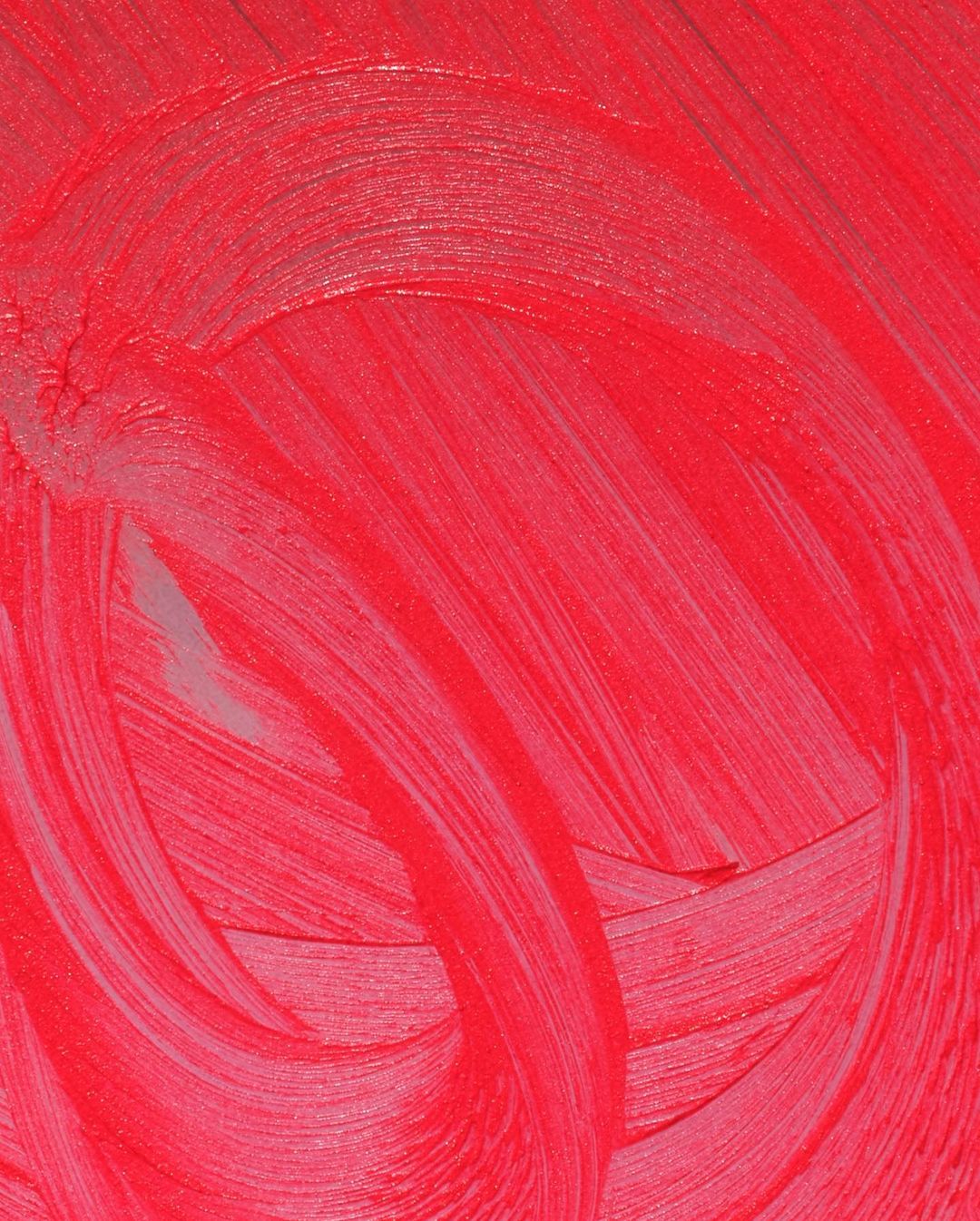 Close-up of bright red paint strokes with visible texture, creating a dynamic abstract pattern and an organic, handmade aesthetic.