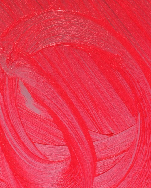 Close-up of bright red paint strokes with visible texture, creating a dynamic abstract pattern and an organic, handmade aesthetic.