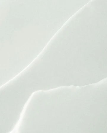 Close-up abstract texture of white marble slab with natural-looking vein patterns for use as a background, template, or design element.