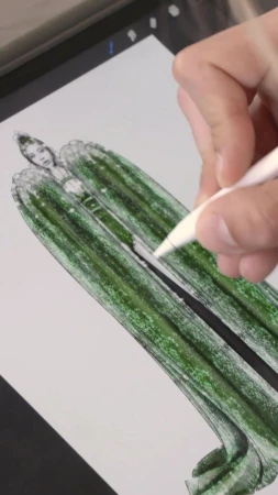 Fashion illustration on a digital tablet: hand drawing a woman's dress with a stylus in green and black, with white background.